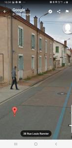 a person walking down a street with a red object at Appartement moderne Roanne in Roanne