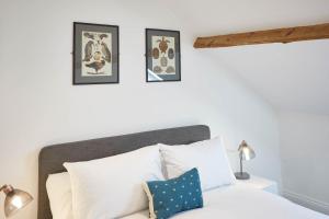 a bedroom with a white bed with three pictures on the wall at Host & Stay - Cornerhouse Apartments in Saltburn-by-the-Sea +58 photos