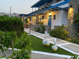 a garden with two bowling balls on the grass at Dorkas Luxury Rooms&Apartments in Livadakia