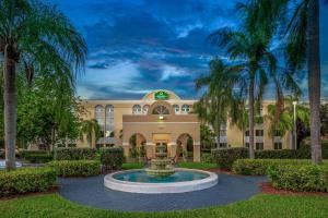 a building with a fountain in front of it at La Quinta by Wyndham Miami Lakes in Miami Lakes