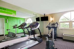 a gym with several tread machines in a room at La Quinta by Wyndham Miami Lakes in Miami Lakes