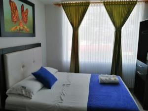 A bed or beds in a room at Hotel Azulejo del Llano