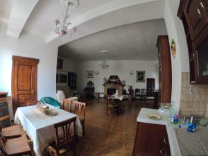 a kitchen and living room with a table and chairs at PENSIONE ITALIA in Bolsena