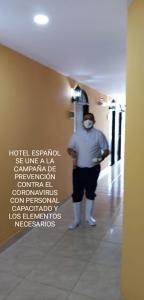 a man standing in a hallway with a mask on at Hotel Español Neiva in Neiva