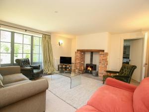 a living room filled with furniture and a fireplace at Kings Cottage - South in Broad Chalke