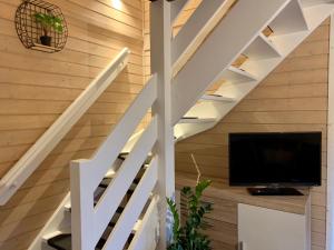 a staircase in a house with a tv underneath it at Zajazd Szałas Food&Rest in Żywiec