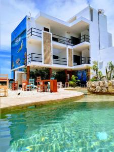 a house with a swimming pool in front of it at Yuum Ha Boutique Hotel in Río Lagartos