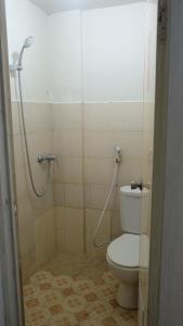 a bathroom with a toilet and a shower at BTX 31 Residence Bintaro in Peladen