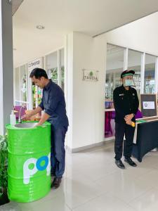 a man in a mask standing next to a trash can at POP! Hotel Sangaji Yogyakarta in Yogyakarta