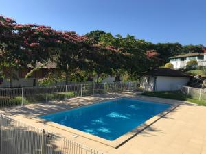 a swimming pool in a yard with a fence at Mendi Alde in Cambo-les-Bains