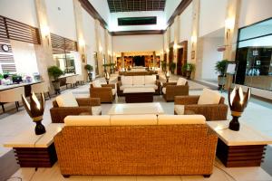 a lobby with couches and chairs in a building at Felda Residence Tanjung Leman in Jemaluang