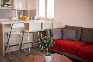 a living room with a couch and a table and a kitchen at Apartman Zoe Vrbnik in Vrbnik