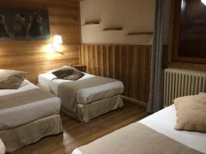 a bedroom with two beds and a television at Alp'azur in L'Alpe-d'Huez