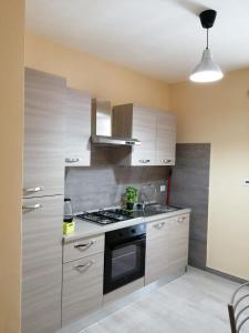 a kitchen with a sink and a stove top oven at STANZA EUCALIPTO in Caserta