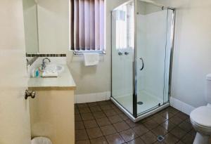 a bathroom with a shower and a sink at Riverview Tourist Park in Margaret River Town