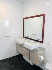 a bathroom with a sink, toilet and mirror at Riverview Tourist Park in Margaret River Town