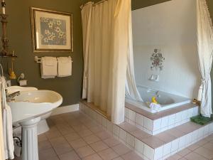a bathroom with a tub and a sink at Haterleigh Heritage Inn in Victoria +74 photos