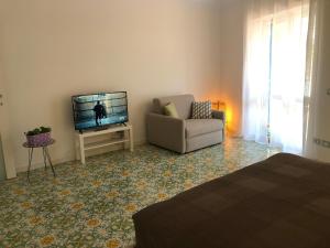 a living room with a couch and a television at Casa Mami - Luxury Apartment and Pool - Sorrento in Sorrento