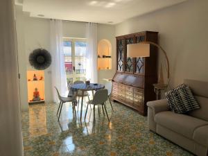 a living room with a table and a couch at Casa Mami - Luxury Apartment and Pool - Sorrento in Sorrento