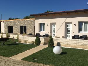 a house with a white ball in the yard at Home Holiday "Da Mamma" in Alba