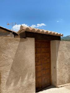 a brown door on the side of a house at Casa del Portón - Housevanlive in Casas Altas