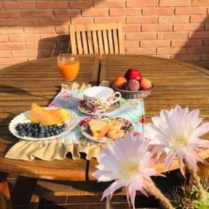 a table with plates of food and fruit on it at B&B Independente in Assago