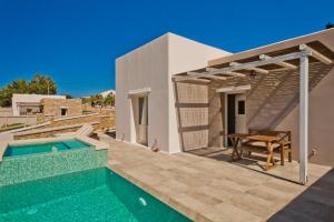 a villa with a swimming pool and a house at Lux View Suites in Kyra Panagia