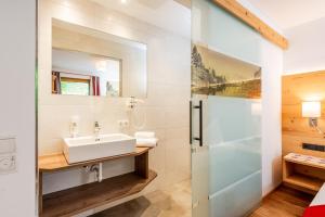 a bathroom with a sink and a shower at Aparthotel Ramsau in Ramsau am Dachstein +186 photos
