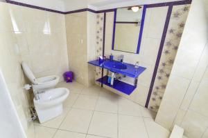 a bathroom with a toilet and a sink and a mirror at SOLEMAREPONZA Casa la Randa in Ponza