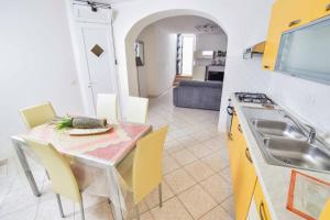 a kitchen and dining room with a table and chairs at SOLEMAREPONZA Casa la Randa in Ponza +11 photos