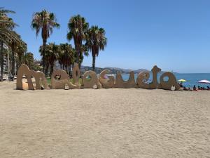 a sign that says miami on the beach at Málaga Beach and Historic centre Malagueta in Málaga