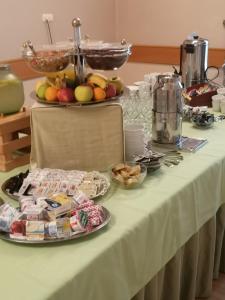 a table with a plate of food on it at Hotel Blaha Lujza in Balatonfüred