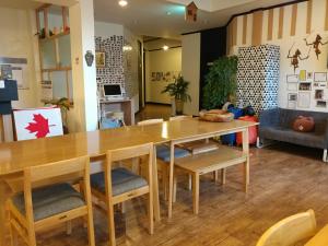 a dining room with a wooden table and chairs at Sokcho & Guesthouse in Sokcho