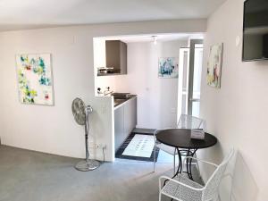 a living room with a table and a kitchen at Great2Stay City Center Apartments Locarno in Locarno