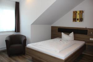 Un pat sau paturi într-o cameră la Hotel Alex