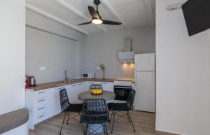 a kitchen with a table and chairs in a room at Pyrgos Exclusive , Sea View & Private Pool in Sellía