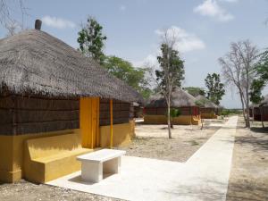 a small hut with a bench in front of it at Campement Hakuna Lodge in Mar Lodj