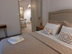 a bedroom with a large bed with towels on it at Σιντηίς- Sinties in Moudhros