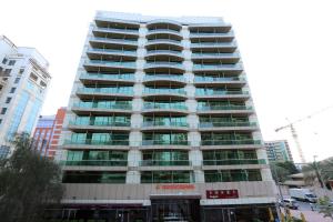 un edificio alto con muchas ventanas en una ciudad en Dunes Hotel Apartment Oud Metha, Bur Dubai, en Dubái