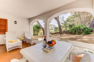 a living room with a white table and chairs at Villa Cala San Vicente - Can Botana 6 in Cala de Sant Vicent