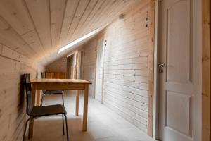 a small room with a wooden table and a chair at Palanga Camping Hostel in Palanga