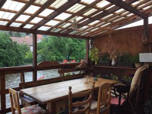 a wooden pergola with a wooden table and chairs at Hostelskippy in Český Krumlov