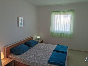 Säng eller sängar i ett rum på Apartments Jelancic