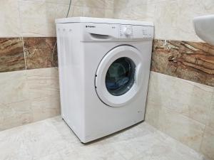 a washing machine in a bathroom next to a sink at Family Apartment for Short-Term Vacation in Primorsko