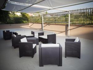 a group of chairs and tables under a tent at Stanza Olmo Caserta in Caserta