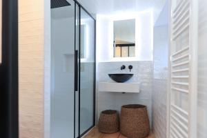 a bathroom with a sink and a mirror at Artist Flat Saint Flour in Saint-Flour