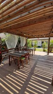 a group of picnic tables under a wooden pergola at Oca Giuliva in Montenero di Bisaccia