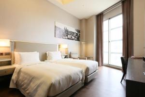 Katil atau katil-katil dalam bilik di City Suites - Taipei Nandong