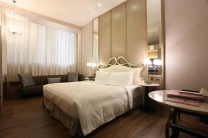מיטה או מיטות בחדר ב-City Suites - Taipei Nandong