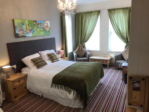 a bedroom with a large bed and a living room at The Wighthill in Sandown